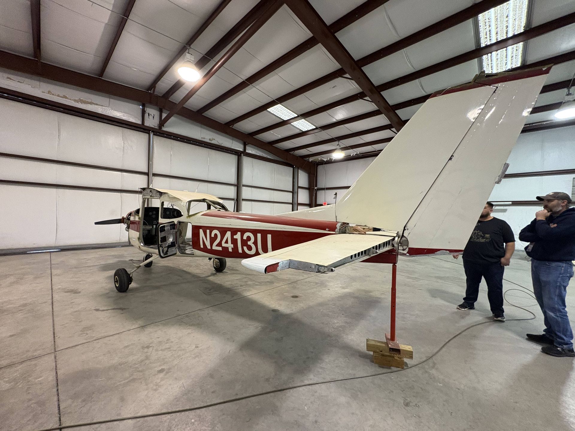 A small red and white plane with the numbers n2413u on it