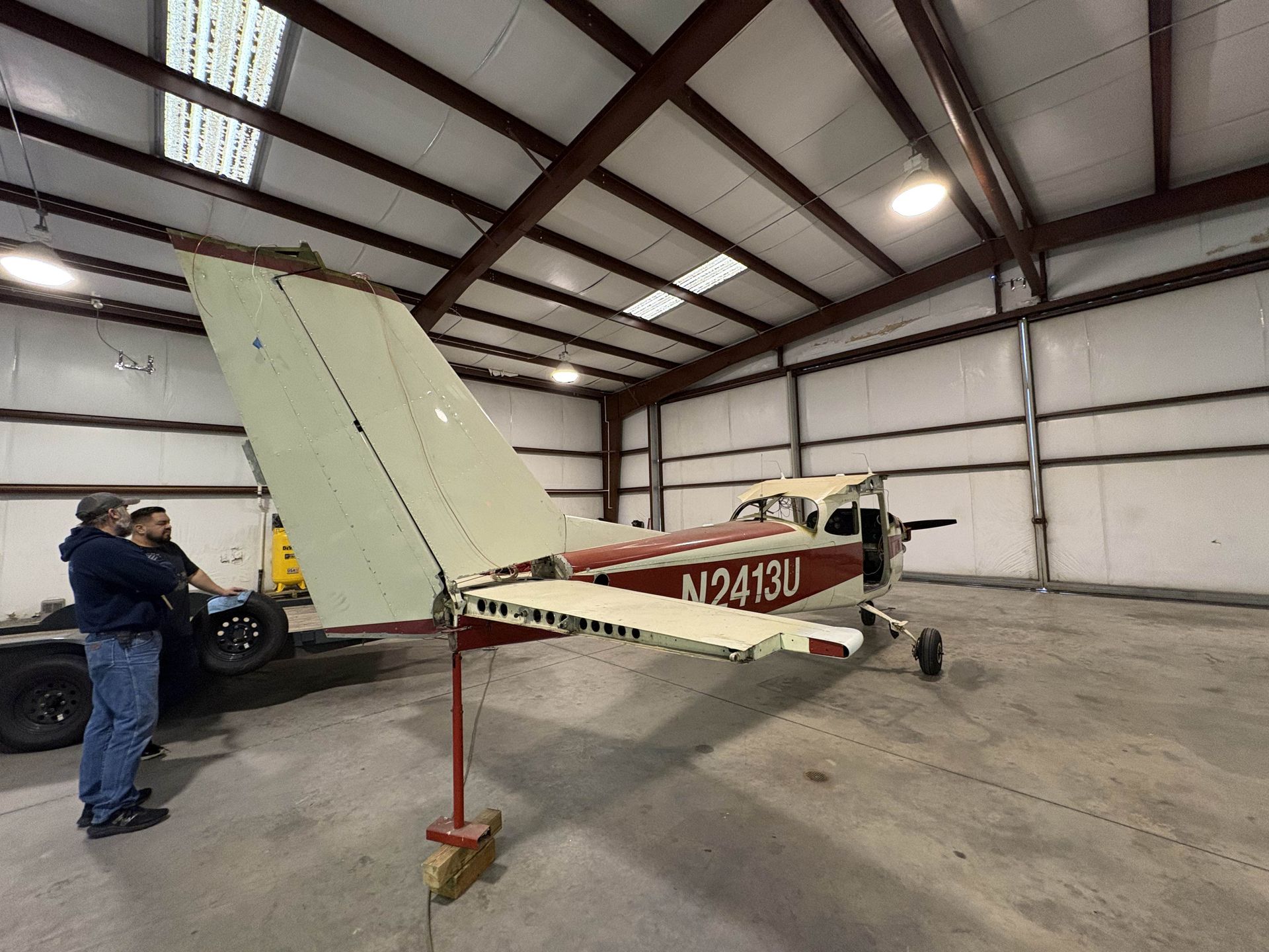 A plane in a hangar with the number n2413u on the side
