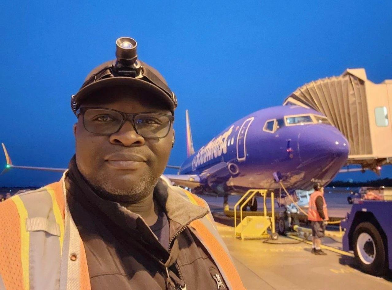 A man is standing in front of a southwest airplane