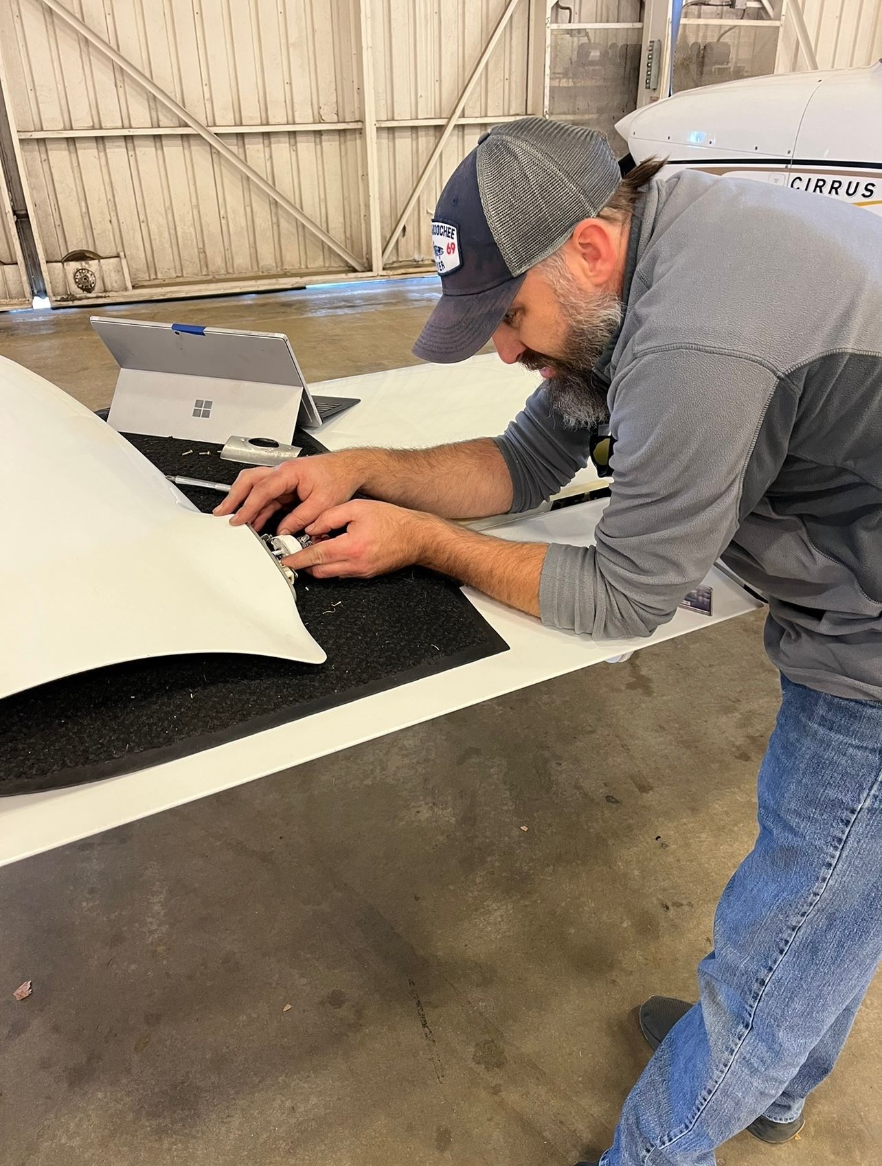 A man is working on a piece of foam on a table.