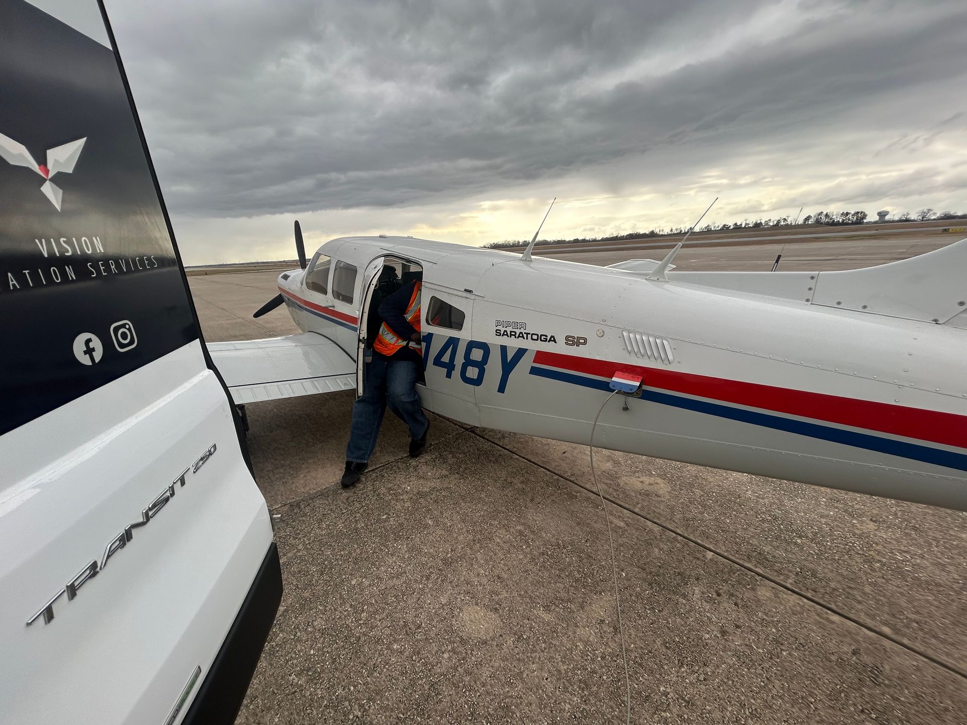 A man is getting out of an airplane with the number 48y on it.