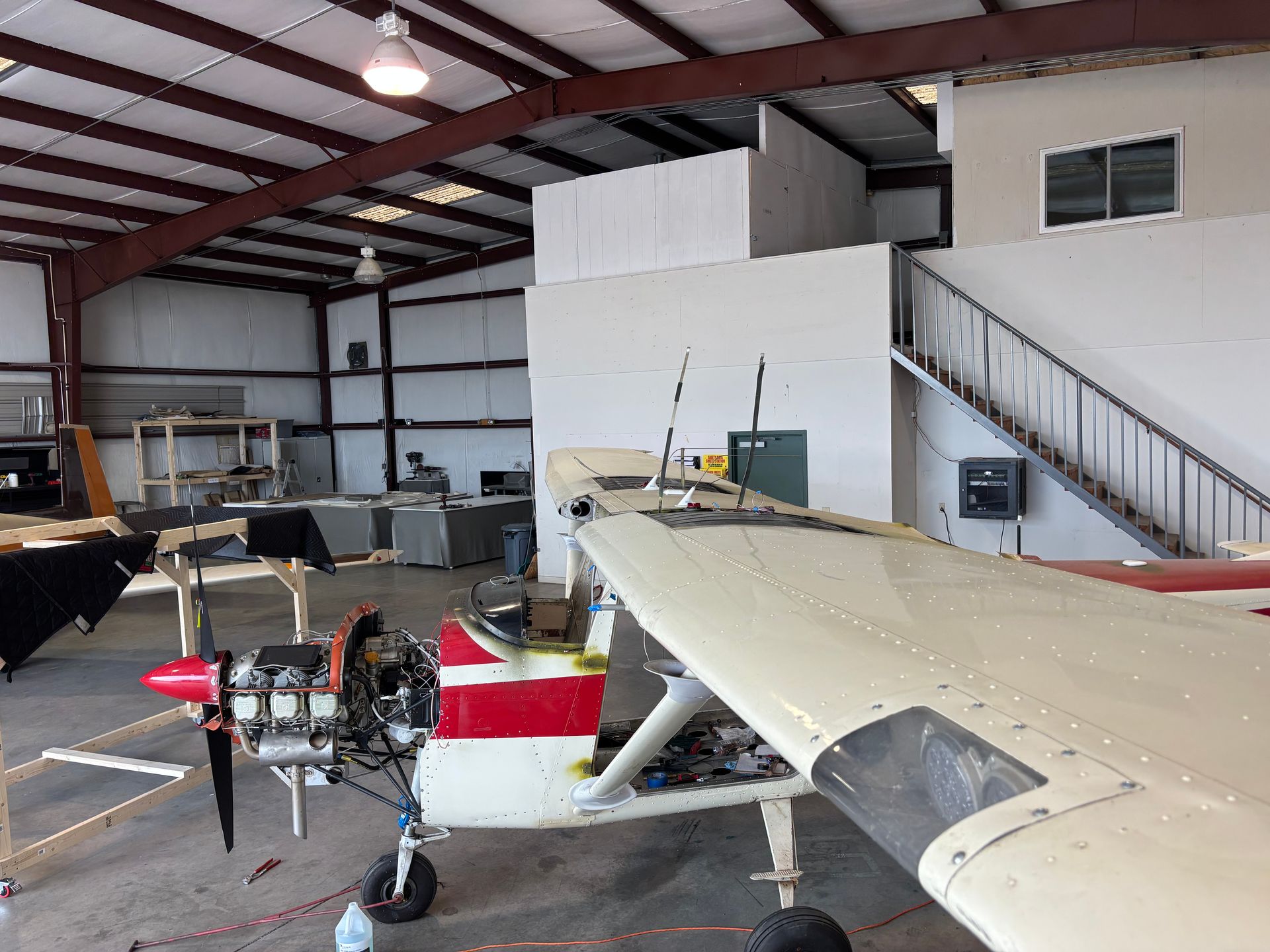 A small plane is parked inside of a building