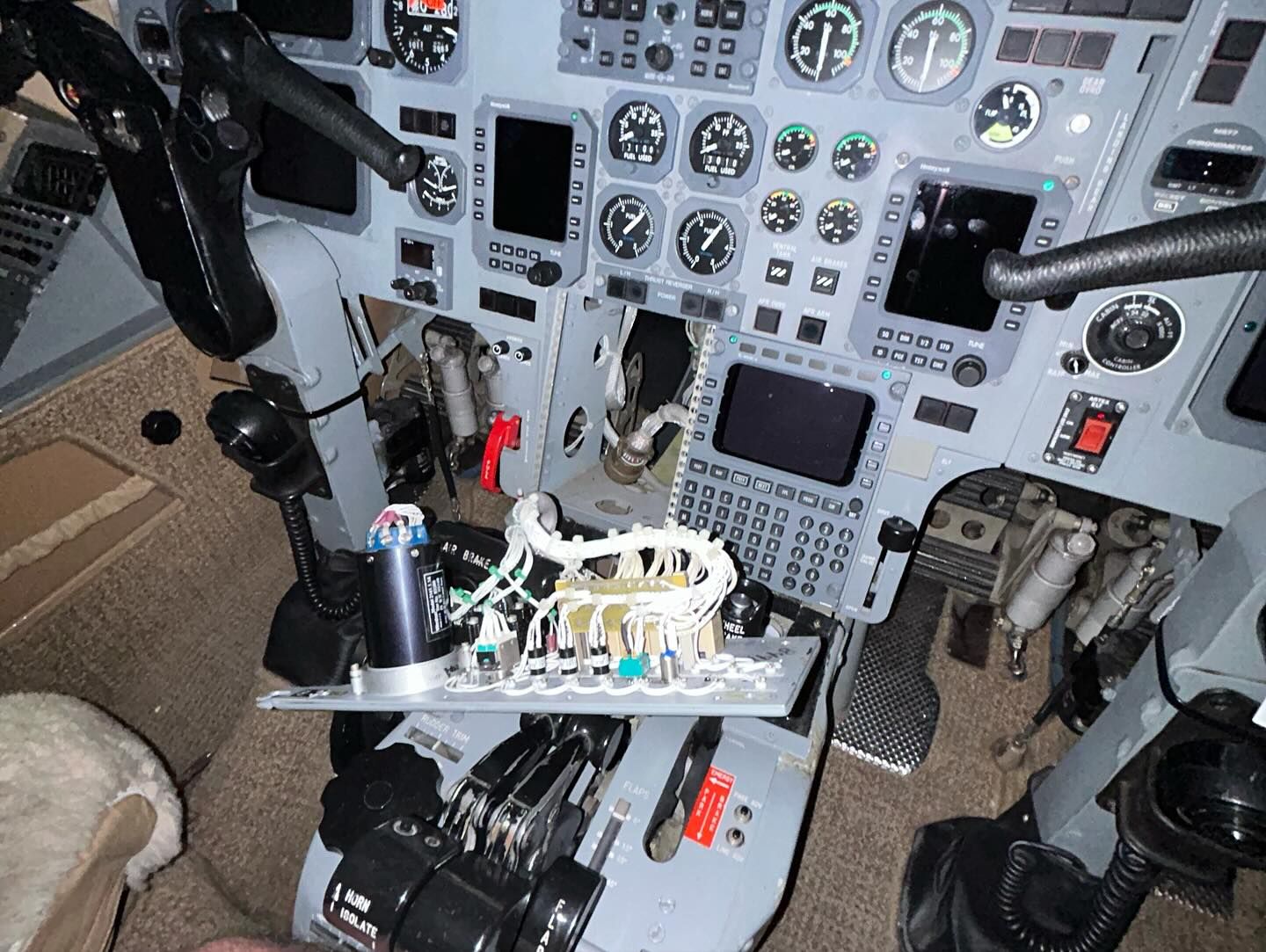 A cockpit of an airplane with a lot of buttons and controls