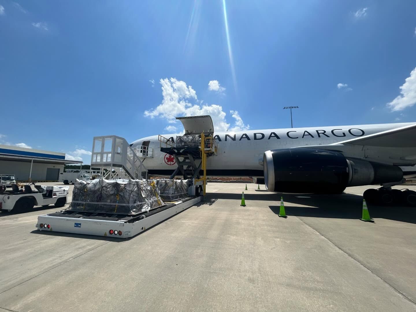 A canada cargo plane is being loaded with cargo