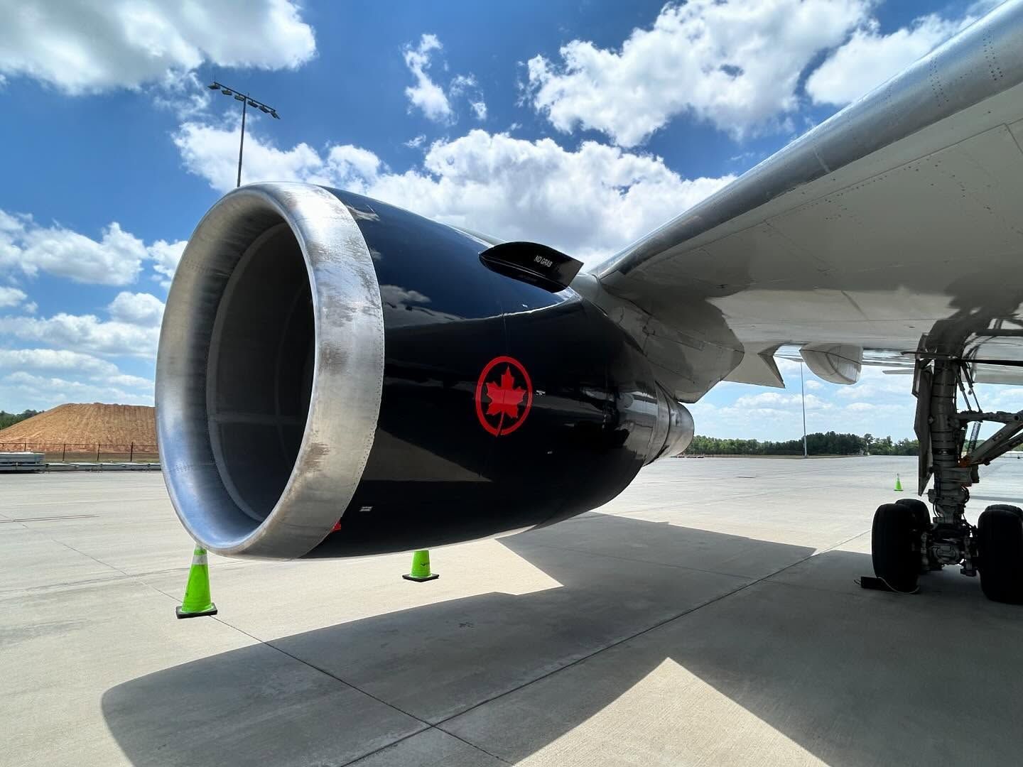 A canadian airlines plane is parked on the tarmac