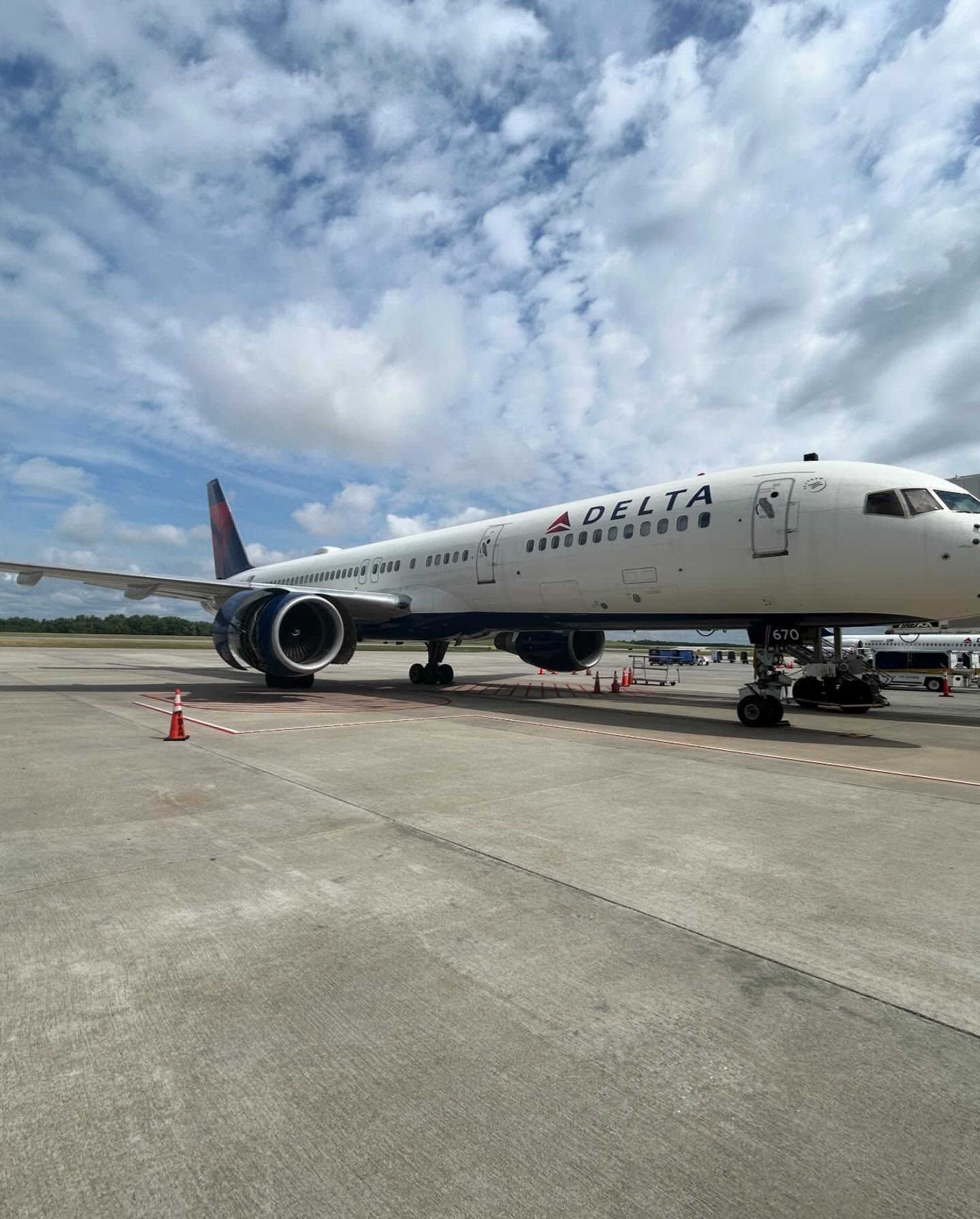 A delta airlines plane is parked on the tarmac