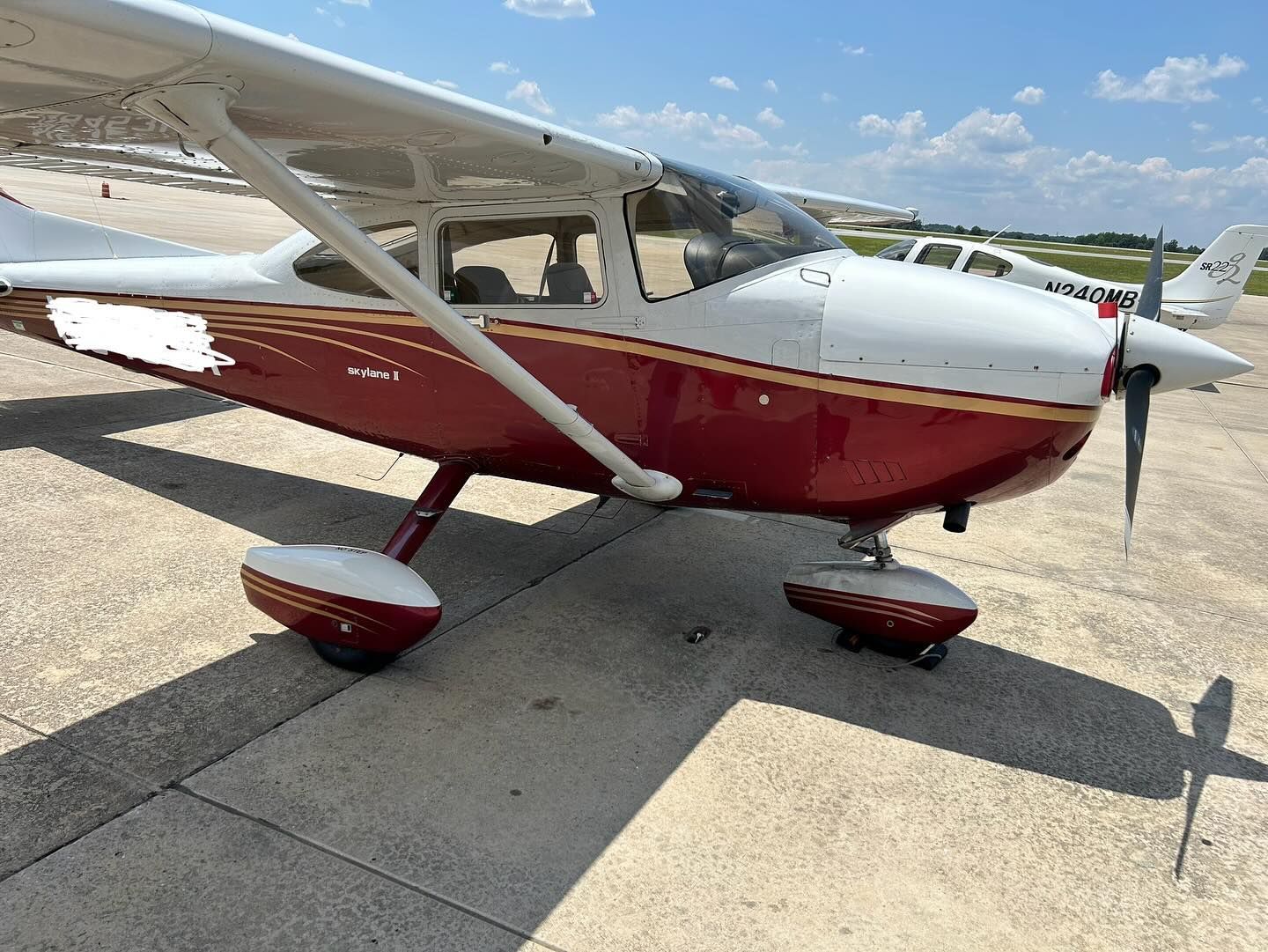 A small red and white plane is parked on a runway.
