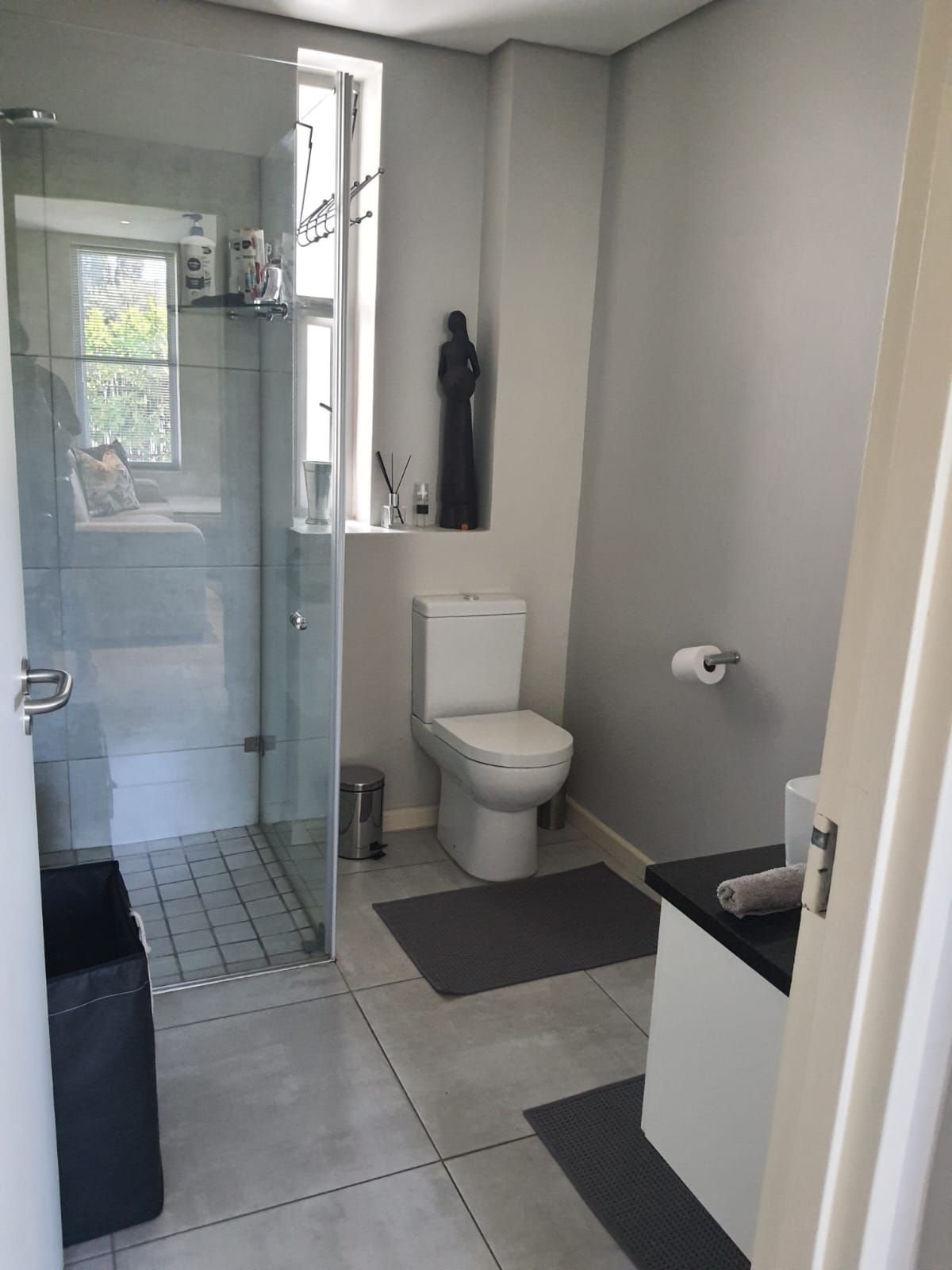 A bathroom with a toilet and a walk in shower