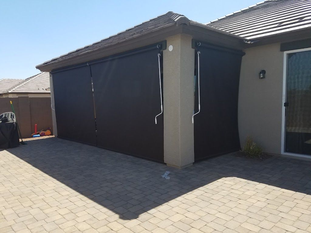 A house with black blinds on the side of it.