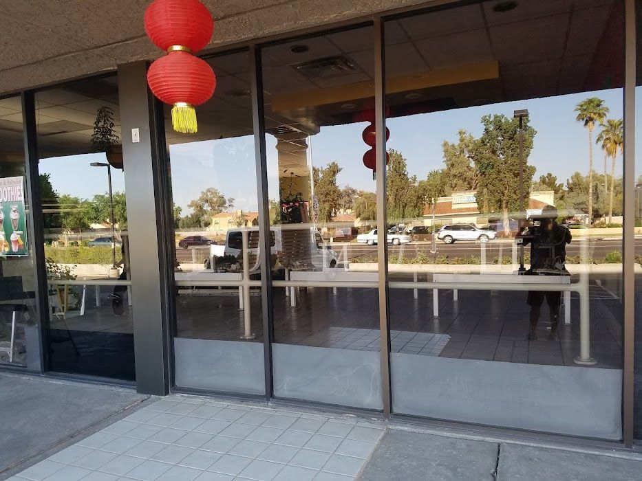 A store front with chinese lanterns hanging from the ceiling