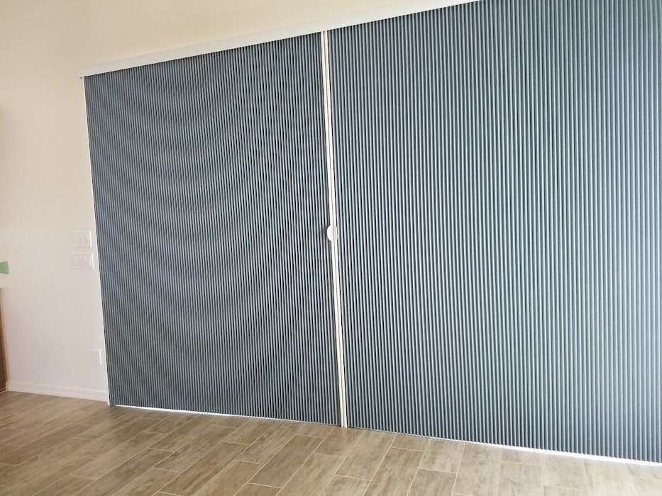 A pair of sliding glass doors with a striped pattern on them.