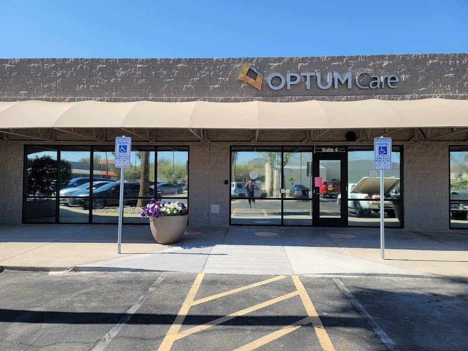 A parking lot in front of a building that says optum care
