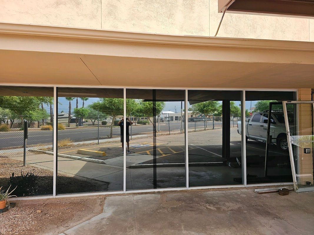 A building with a lot of windows and a car parked in front of it.