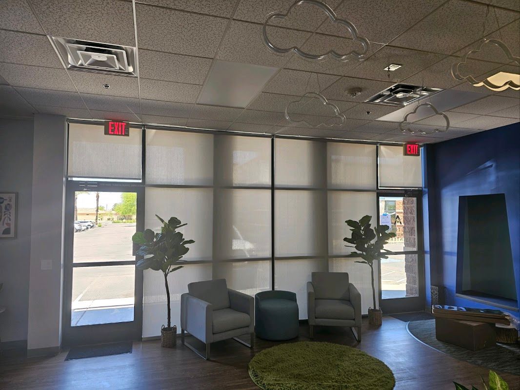 A room with a lot of windows and chairs in it