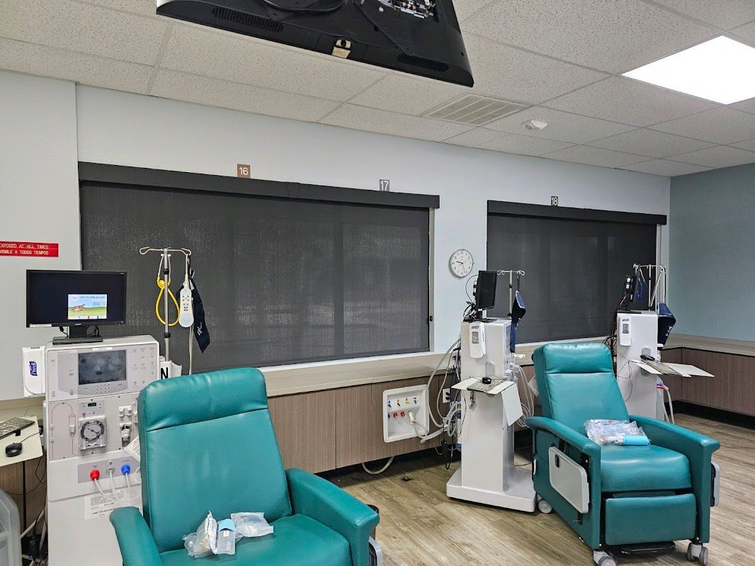 A hospital room with a lot of chairs and machines.