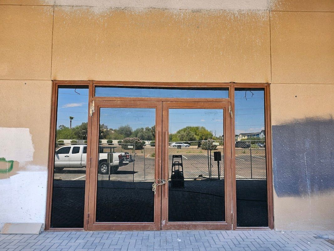 A building with a lot of windows and a truck parked in front of it