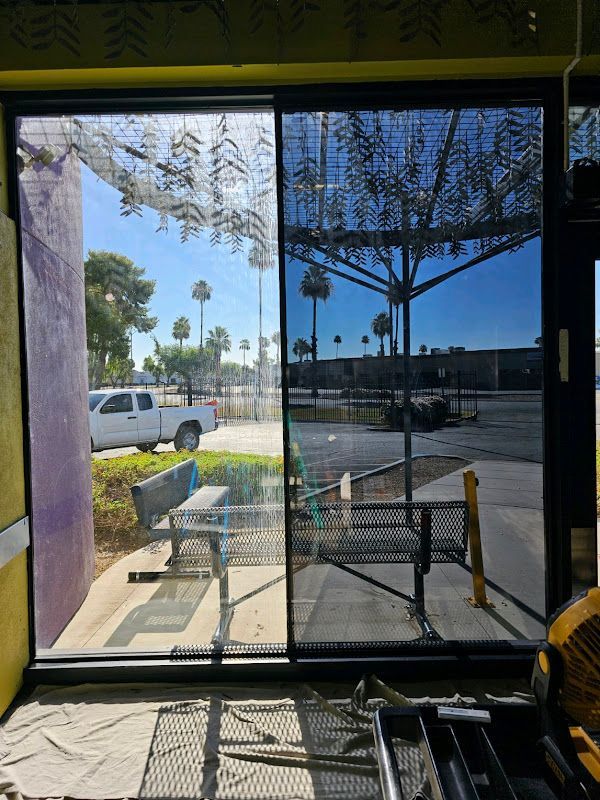 A sliding glass door with a view of a parking lot.