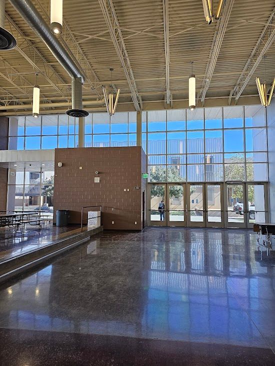A large room with a lot of windows and tables.
