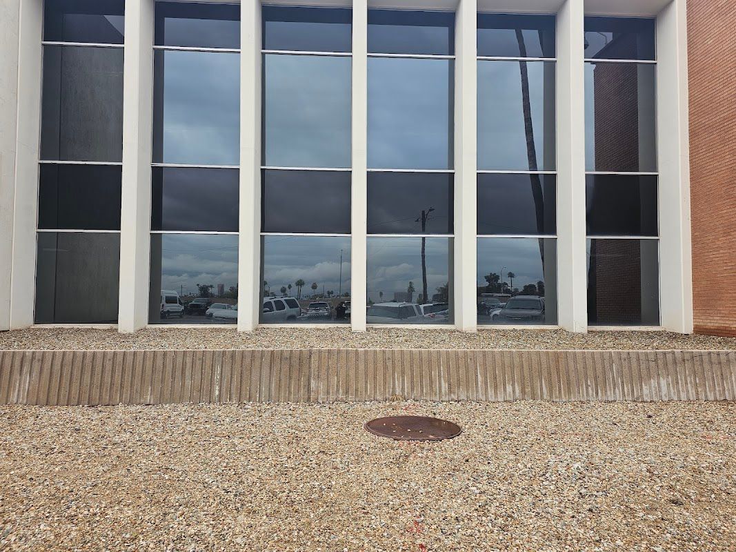 A building with a lot of windows and a manhole cover