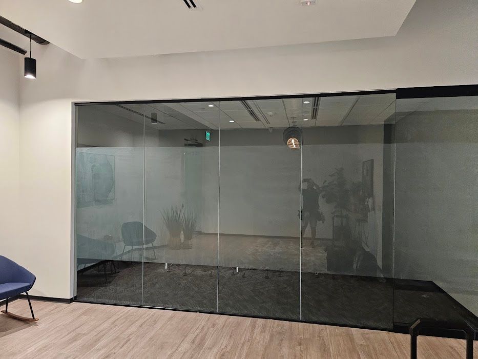 A room with sliding glass doors and a wooden floor.