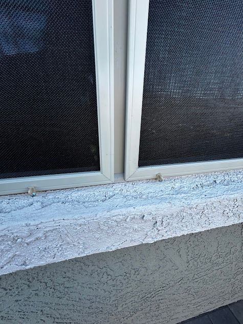 A close up of a window with a screen on it.