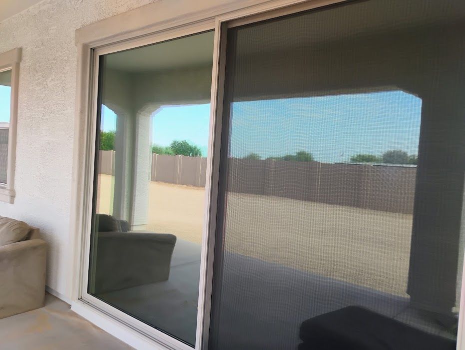 A sliding glass door with a screen on it