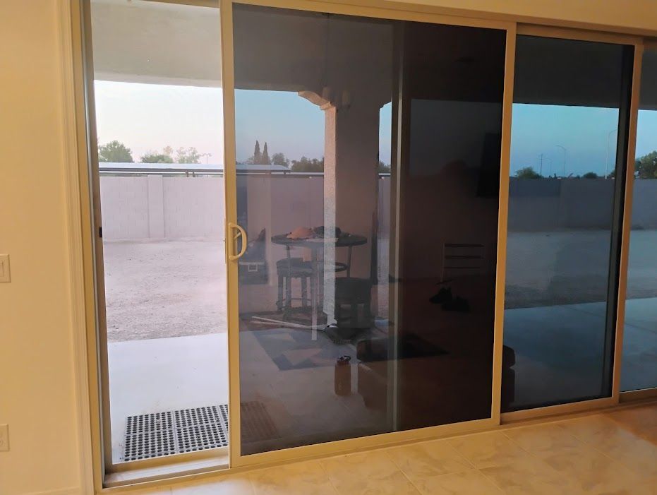 A sliding glass door is open to a patio in a living room.