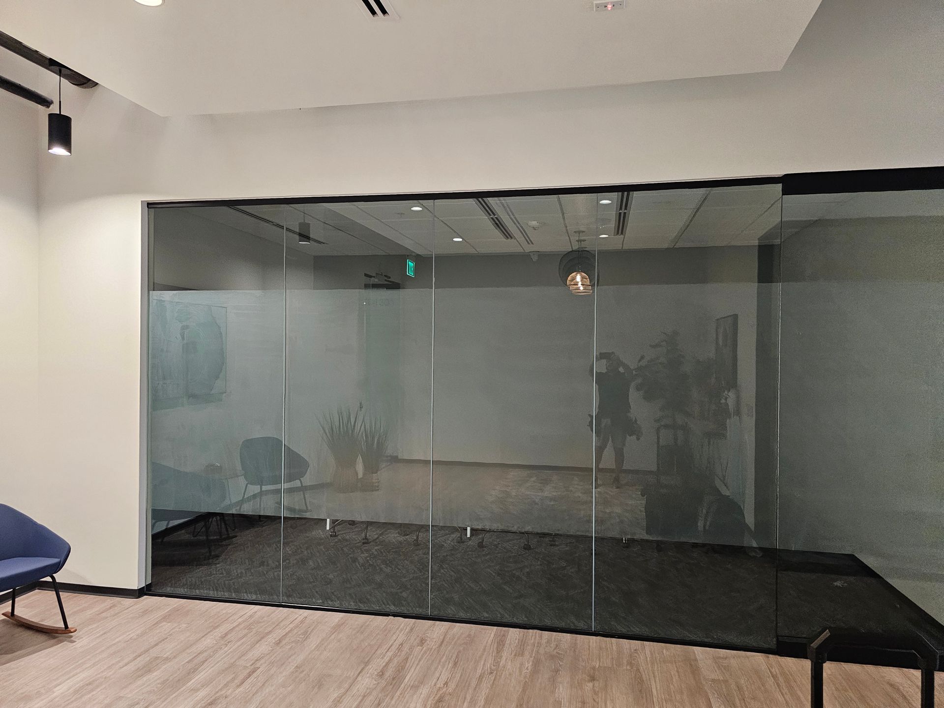 A room with sliding glass doors and a chair in it.