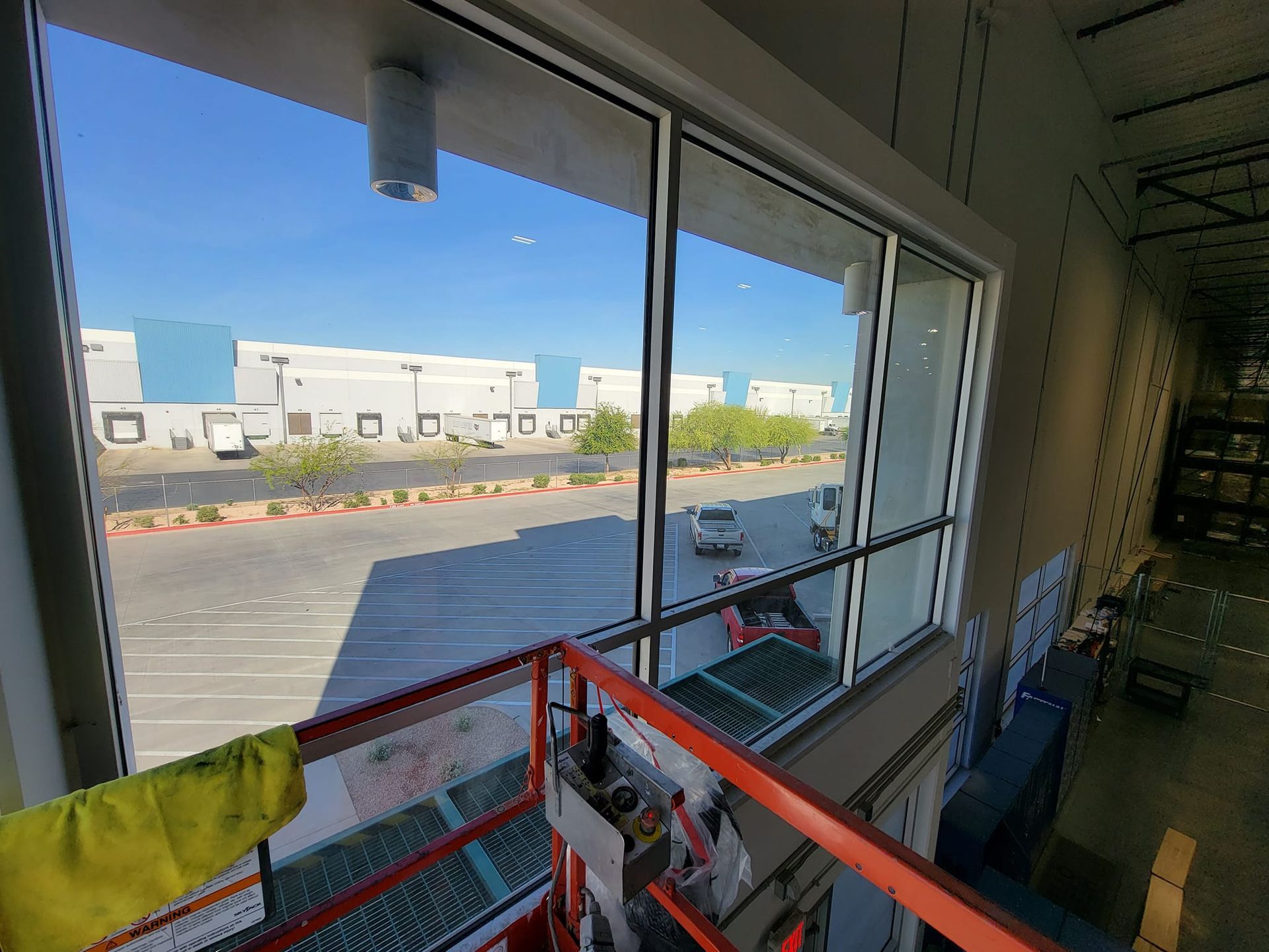 A large window in a building with a view of a parking lot.