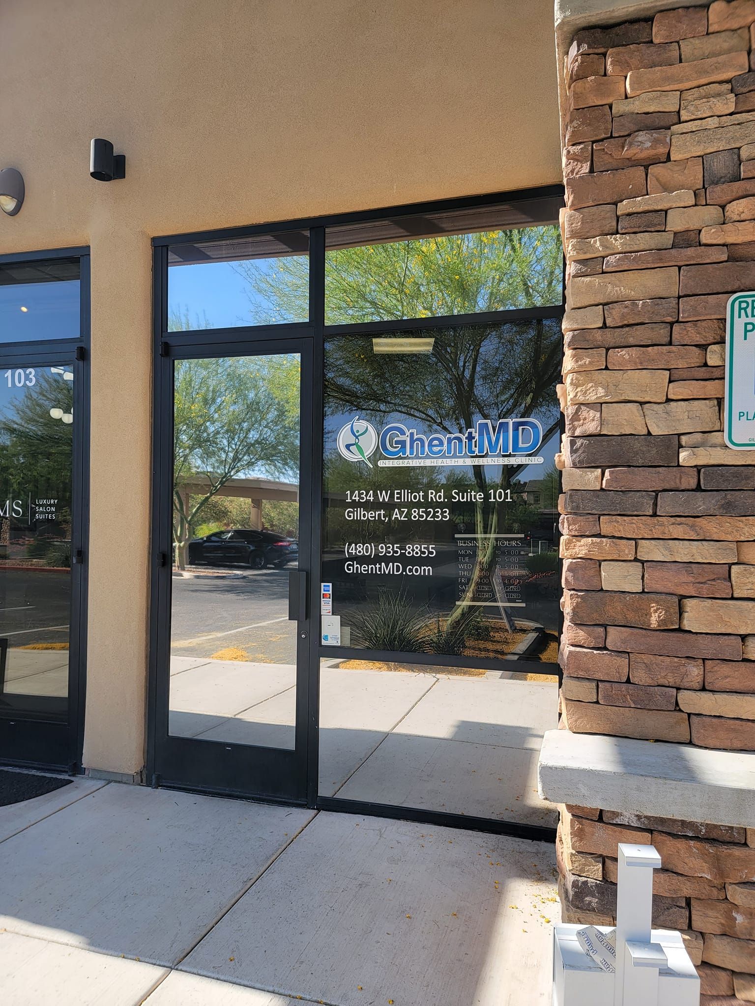 A store front with a glass door and a brick wall.