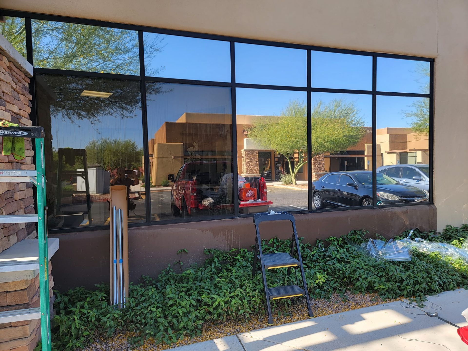 A building with a lot of windows and a ladder in front of it.