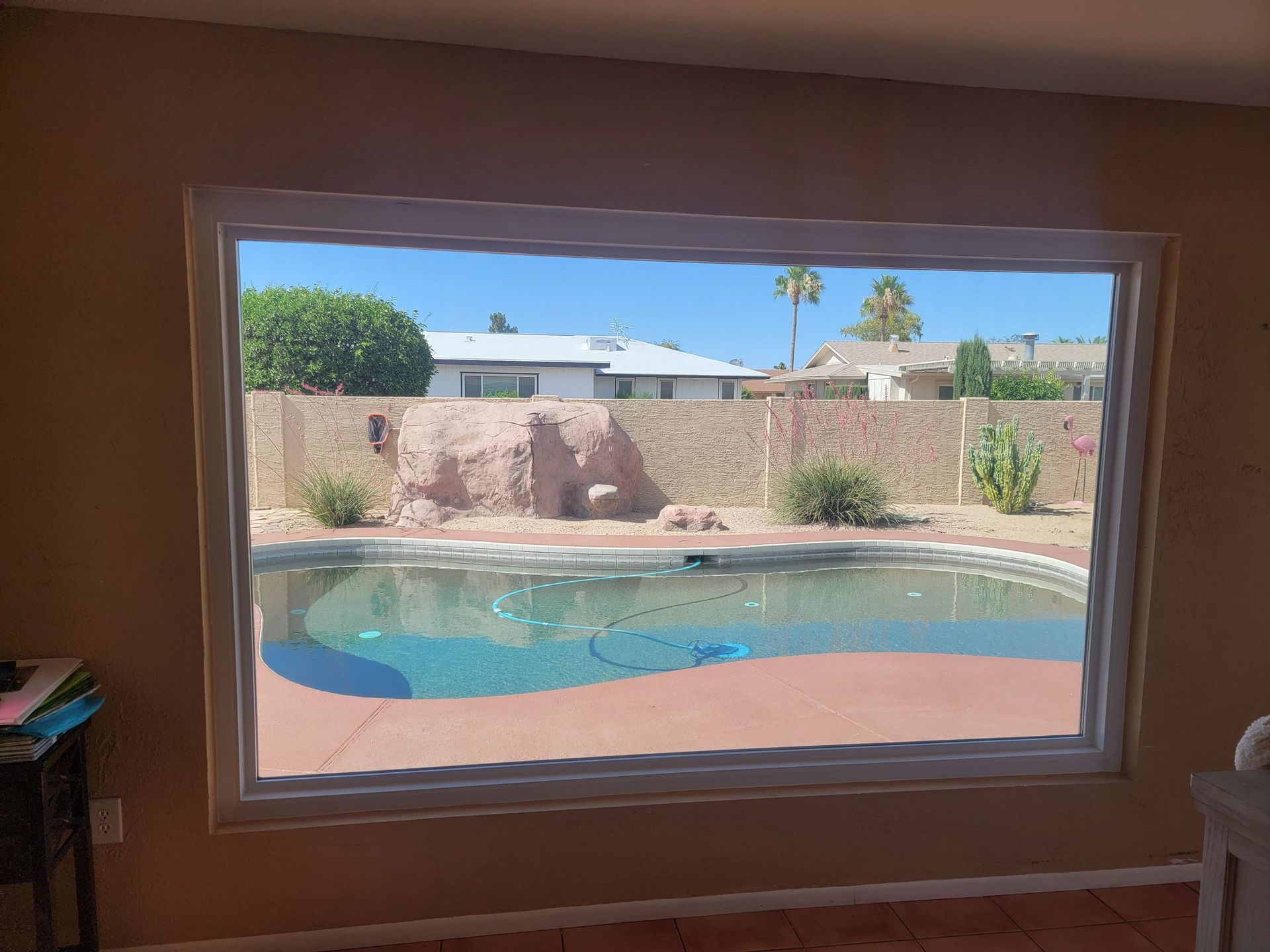 A large window with a view of a swimming pool.