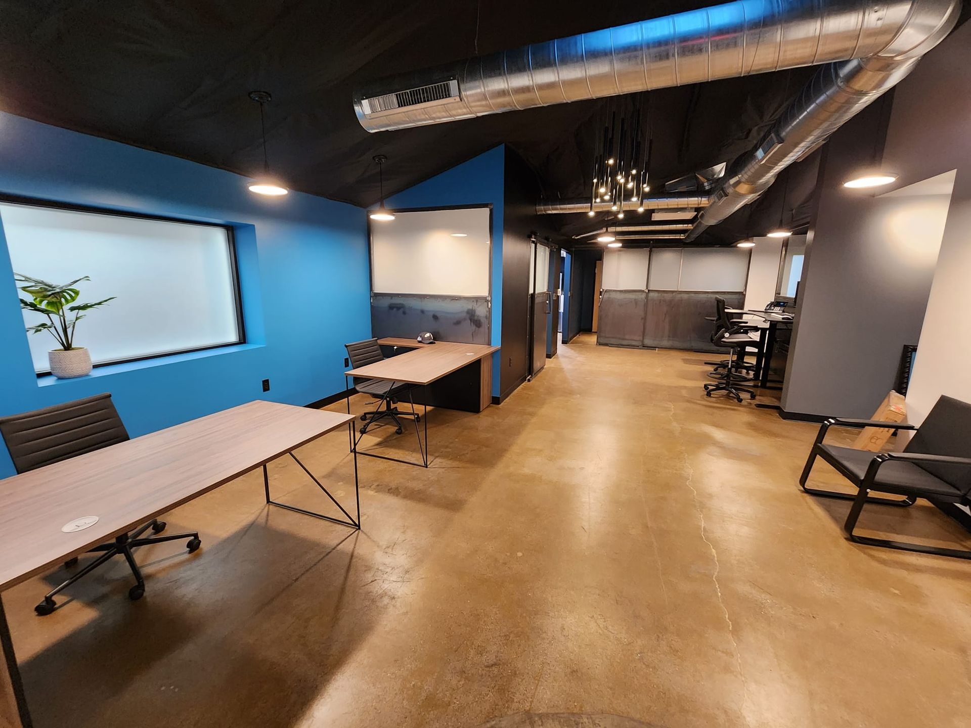 A large room with a table and chairs in it.