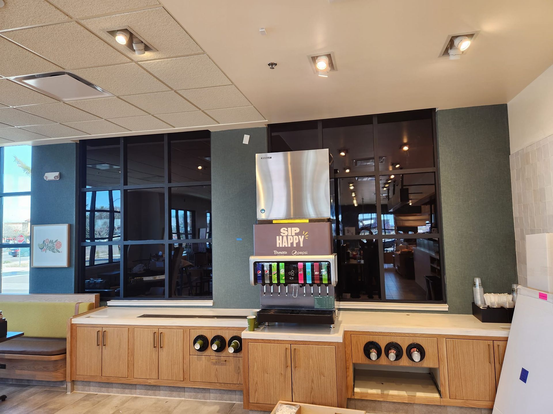 A restaurant with a beverage dispenser in the middle of the room.