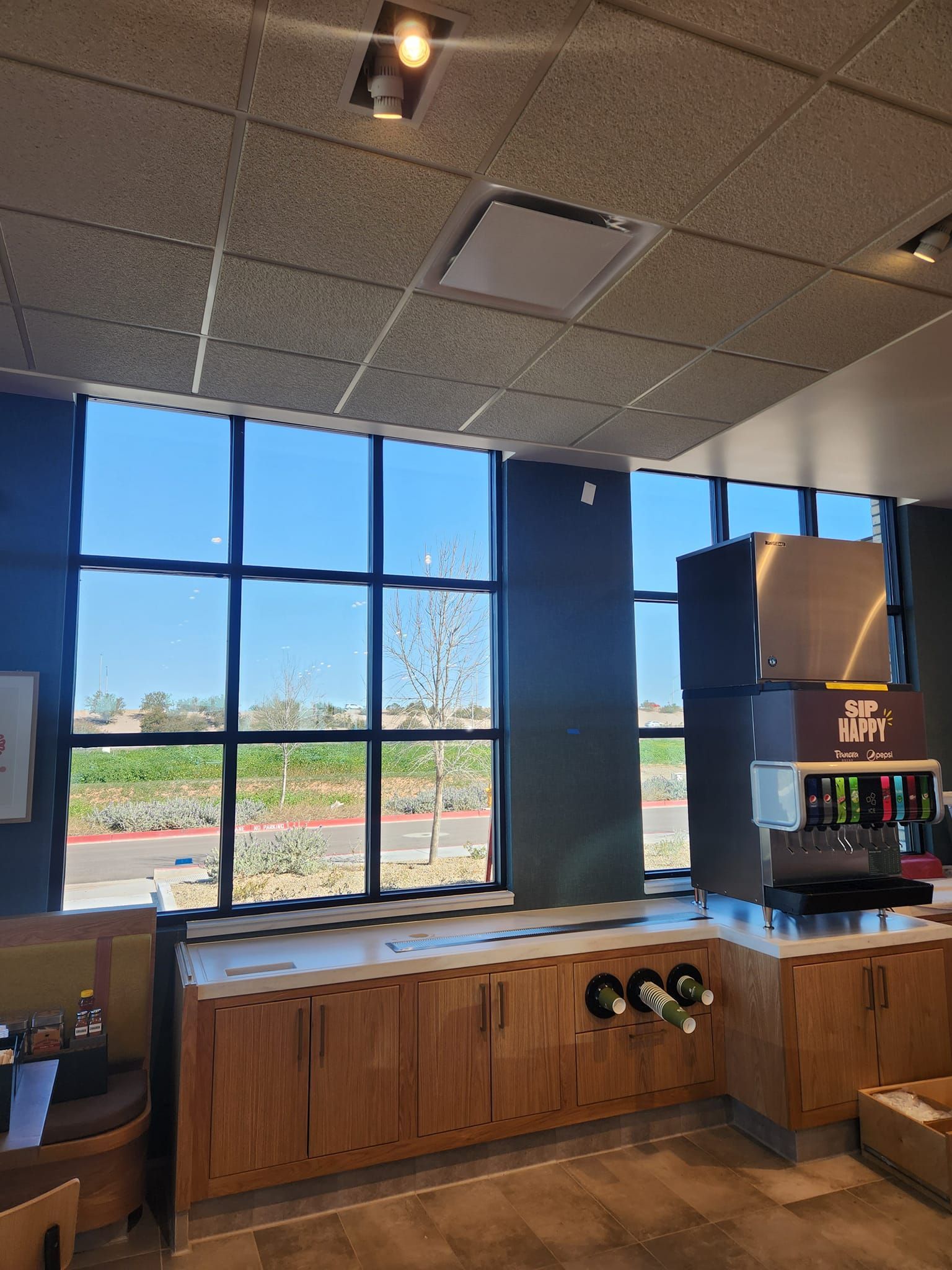 A restaurant with a lot of windows and a counter
