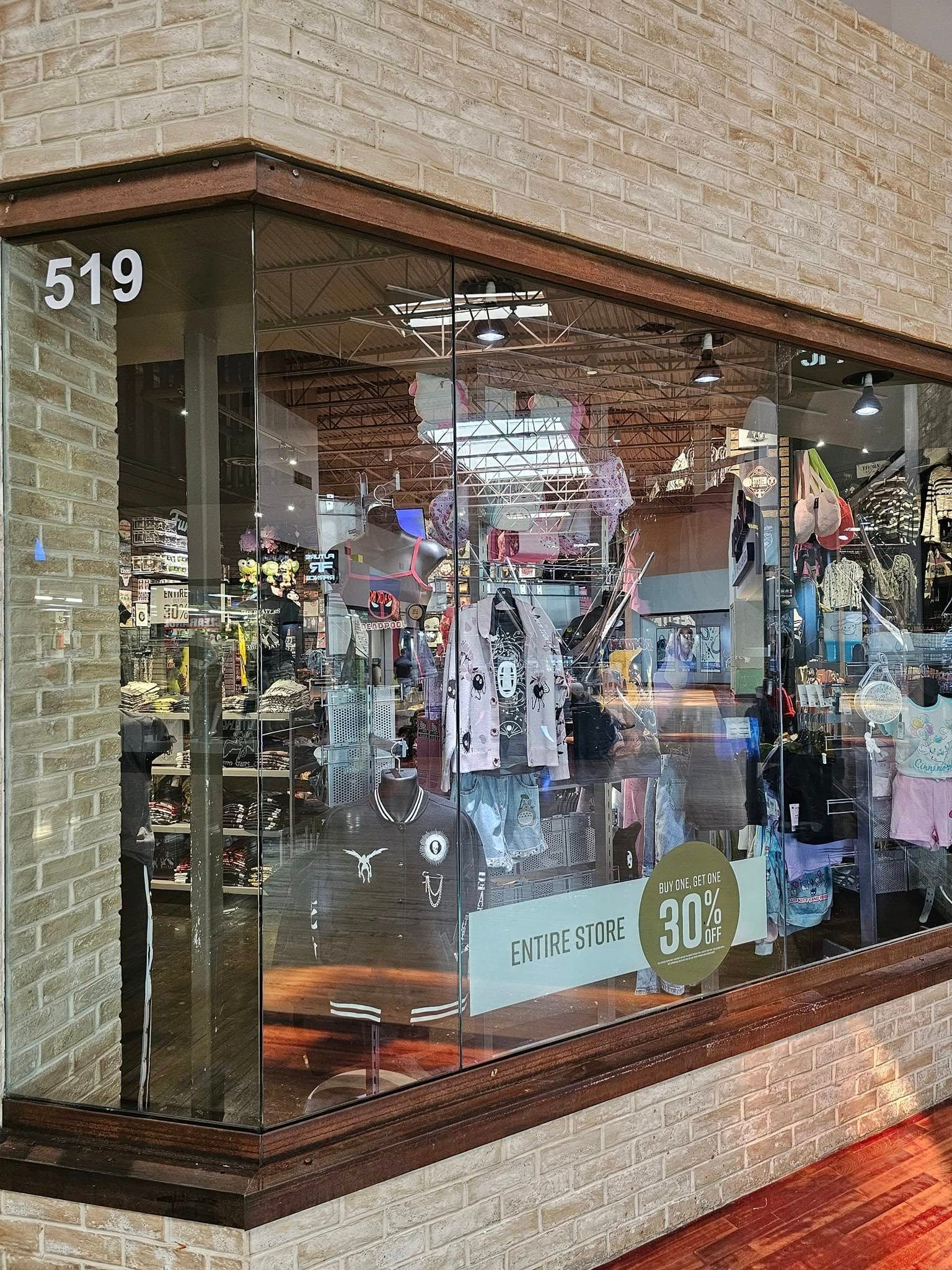 A store front with a glass window and a brick wall.
