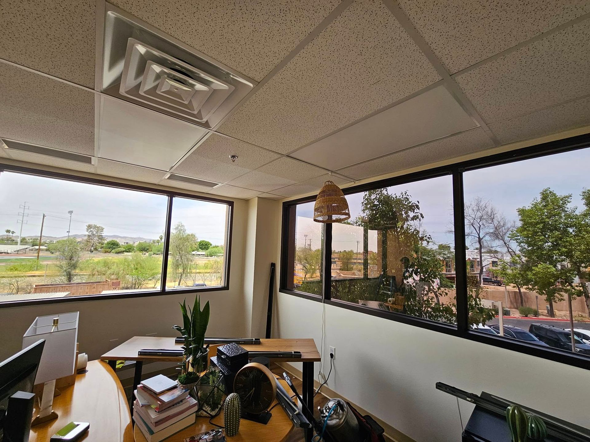 A room with a lot of windows and a ceiling fan that says wex