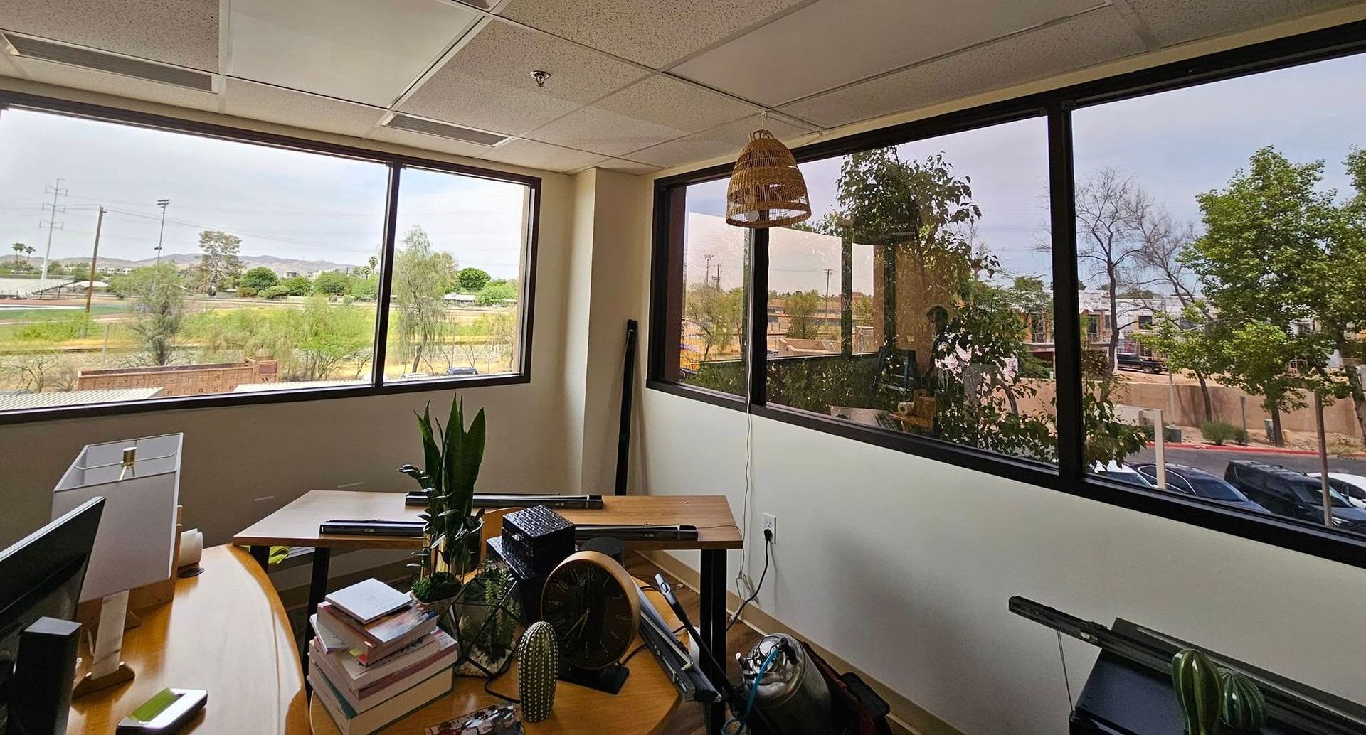 A room with a lot of windows and a desk