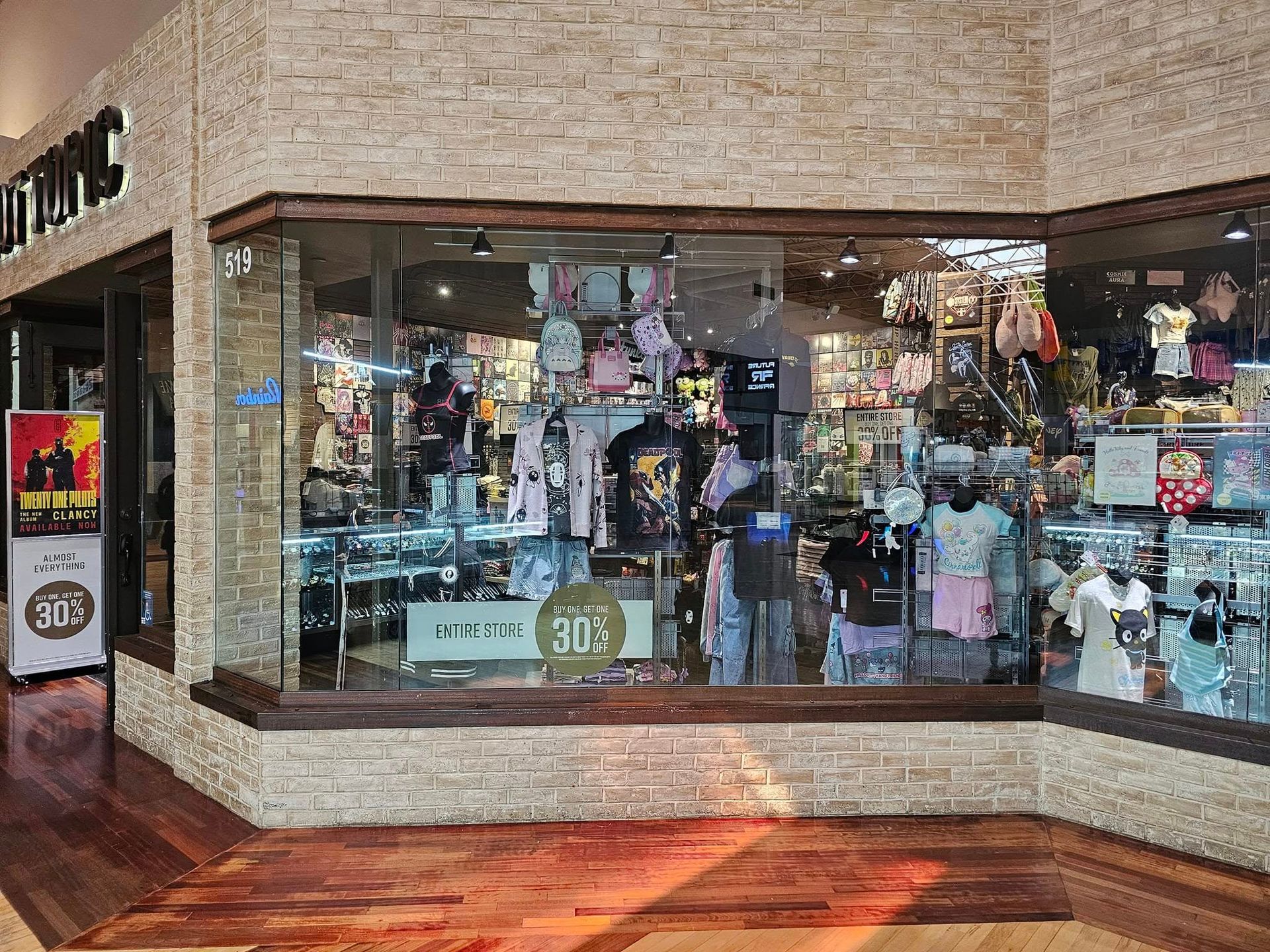 A store front with a lot of clothes in the window.