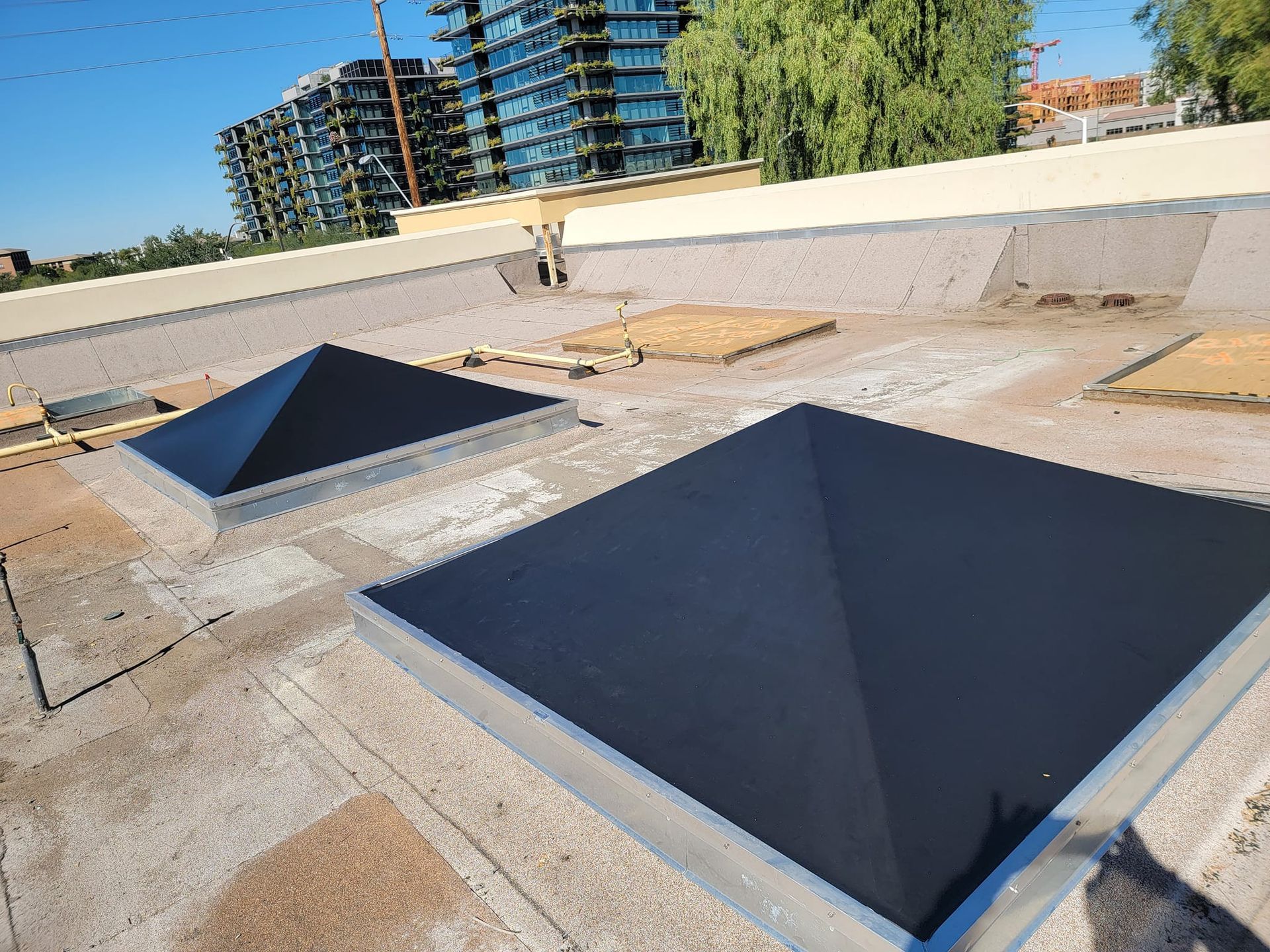 There are two square skylights on the roof of a building.