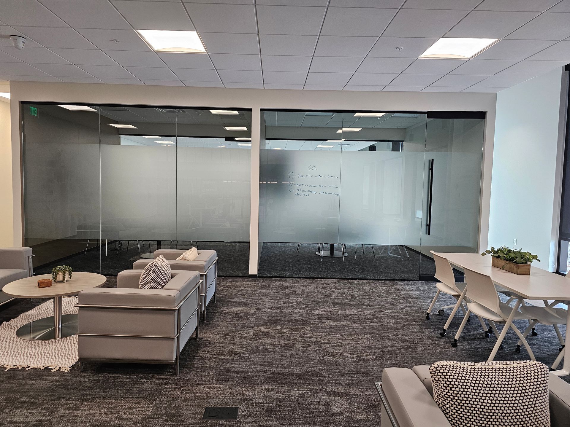 A large room with a lot of furniture and a glass wall.