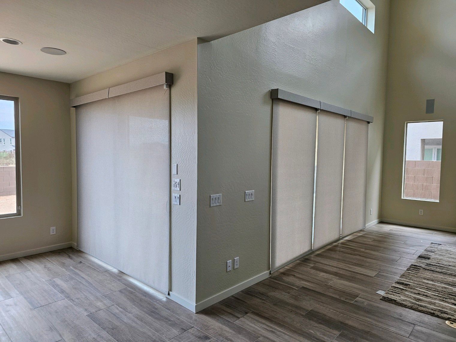 A living room with hardwood floors and sliding glass doors.