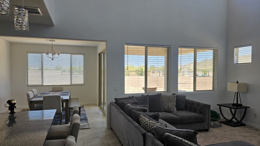 A living room with a couch , chairs , and a table.