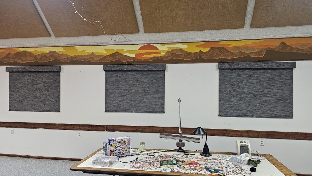 A room with a table and a painting on the wall