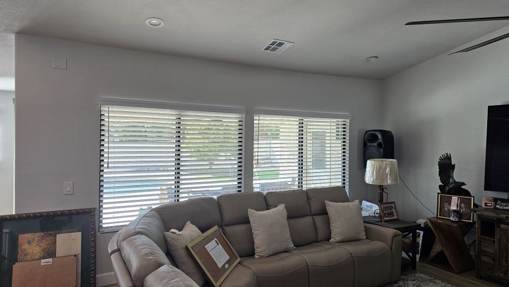 A living room with a couch and a television.