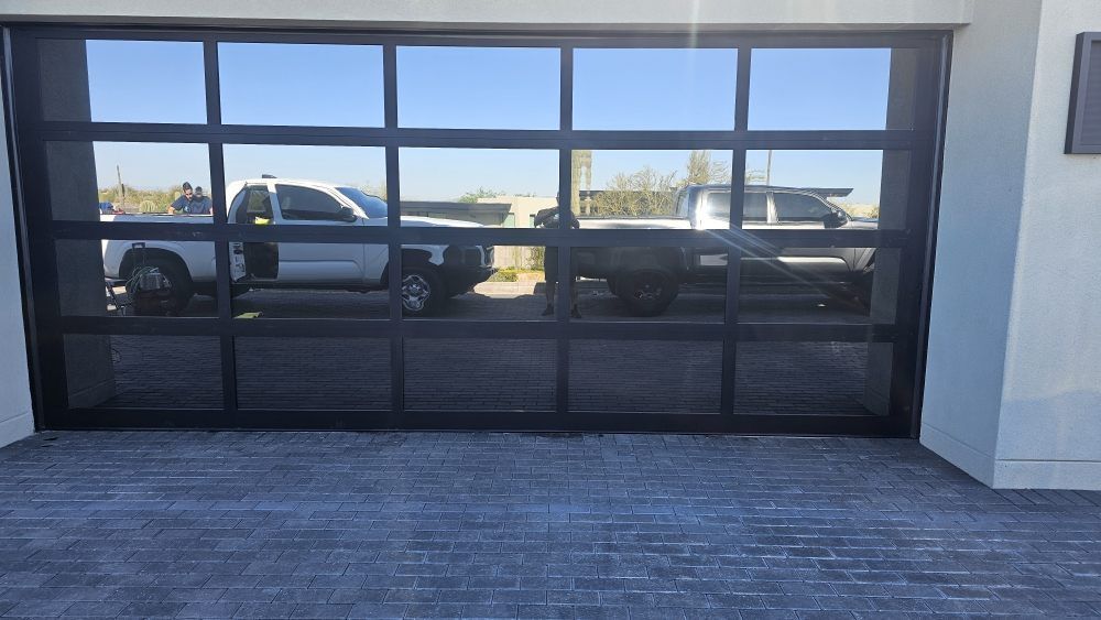 A garage door with a lot of windows and a truck parked in it.