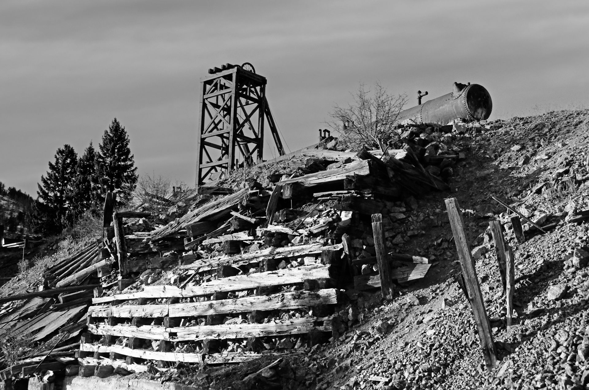 A black and white photo of an old abandoned mine.