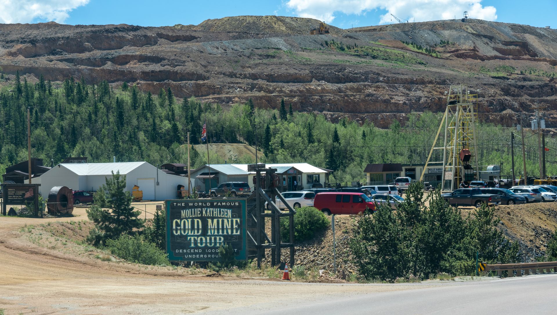 An old mine tour is advertised on a sign