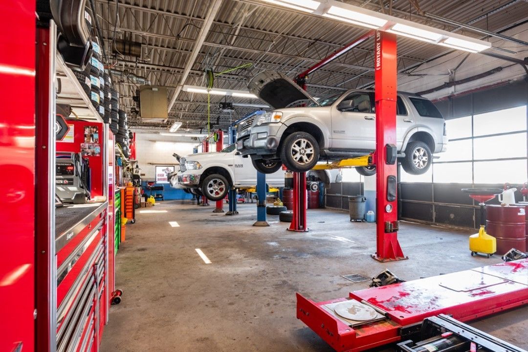 A Car Sitting On A Lift In A Garage — Wilbraham, MA — Ken’s Automotive