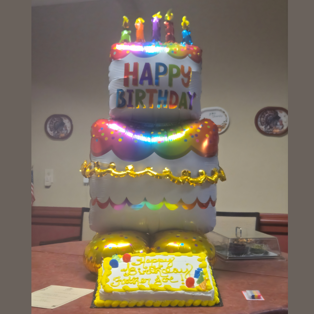 A large birthday cake balloon with 